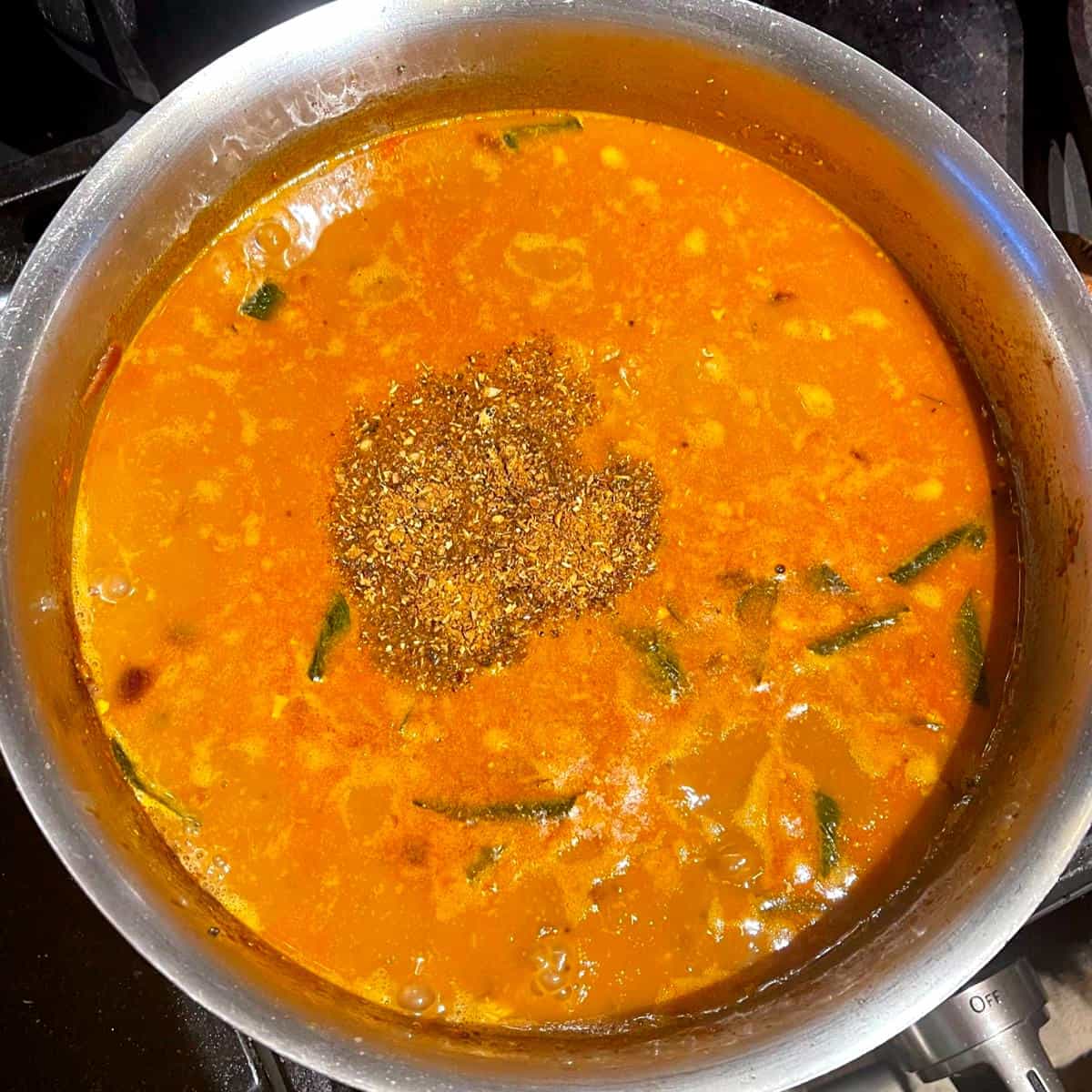 Garam masala added to black-eyed peas curry.