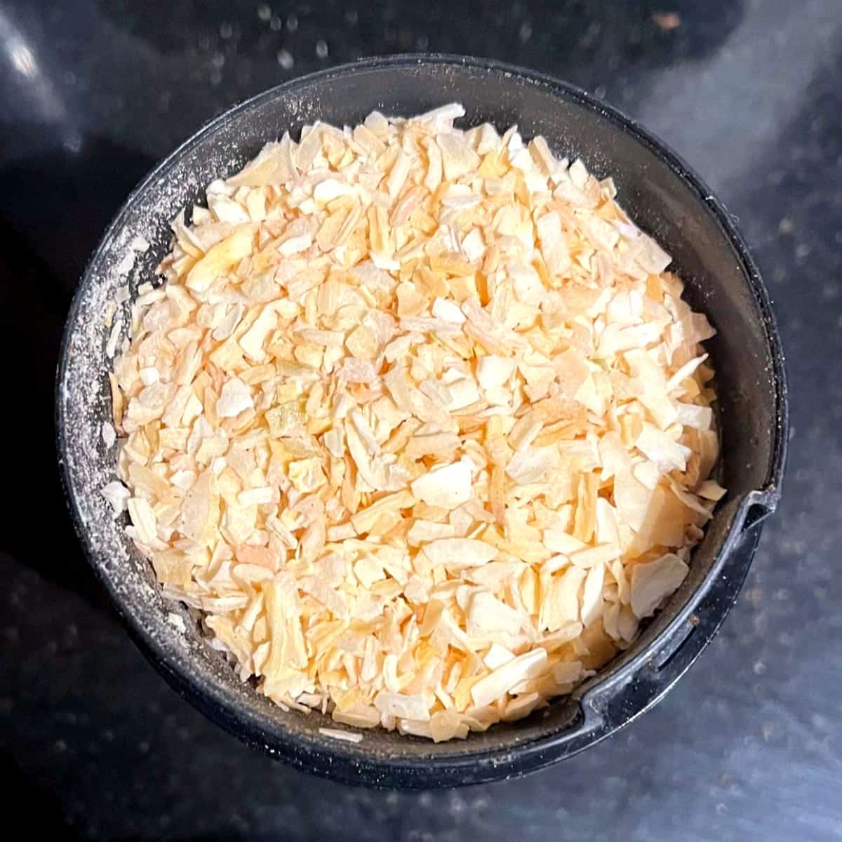 Onion flakes added to spice grinder.