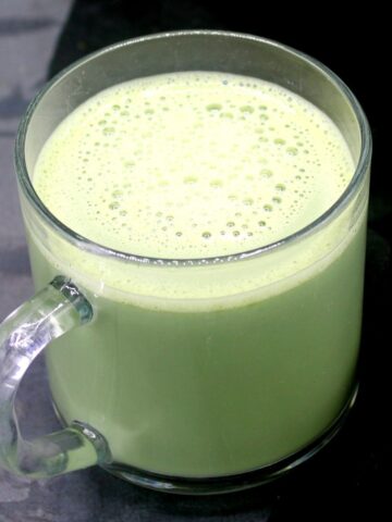 Matcha green tea latte with ginger in cup.