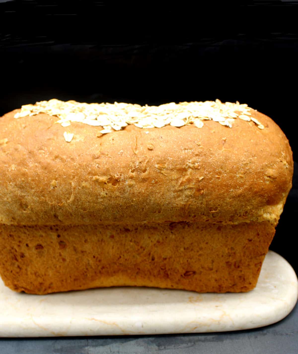 Oatmeal bread on marble board.