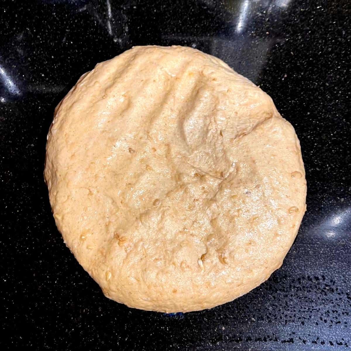 Risen dough turned out of bowl.