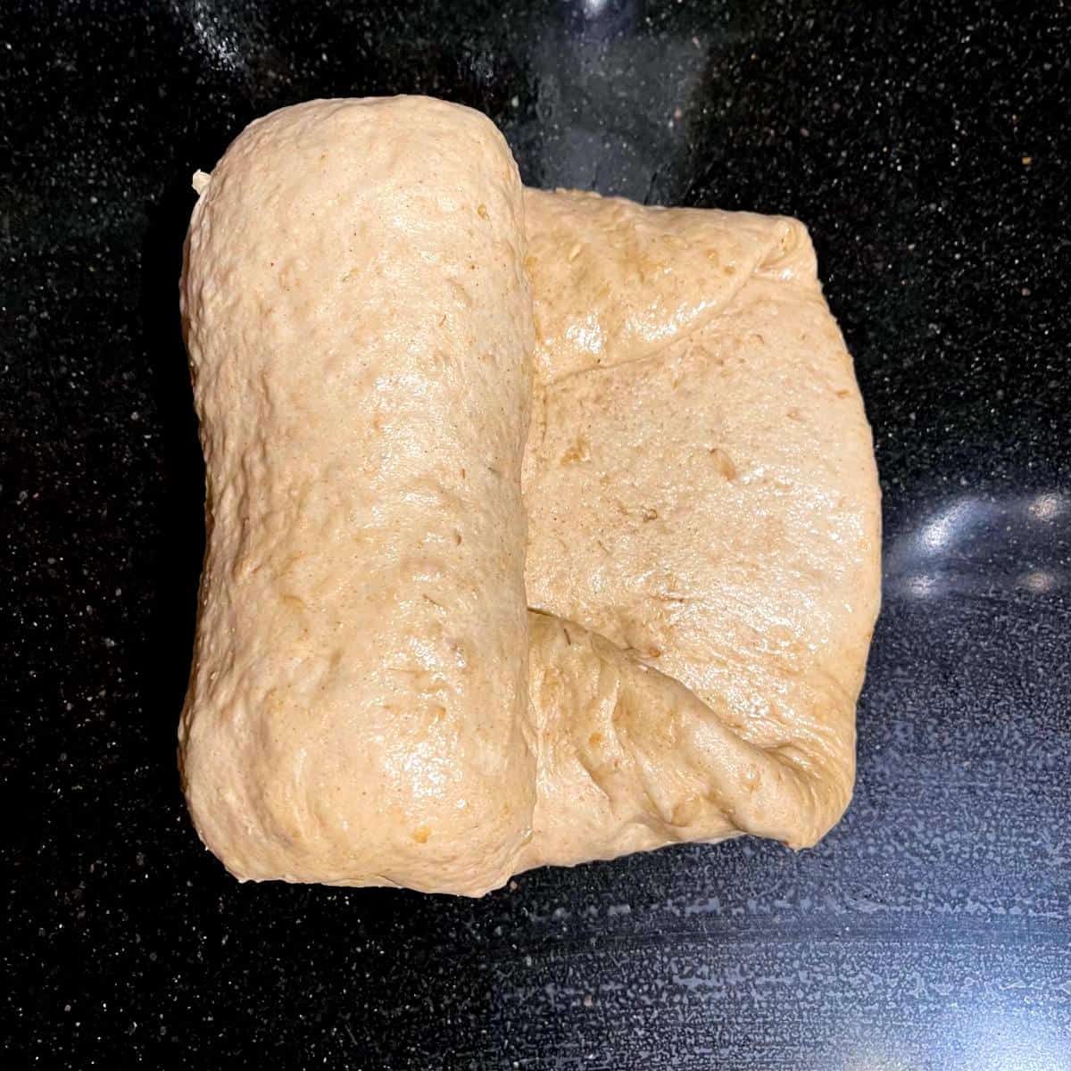 Folding of dough for oatmeal bread.