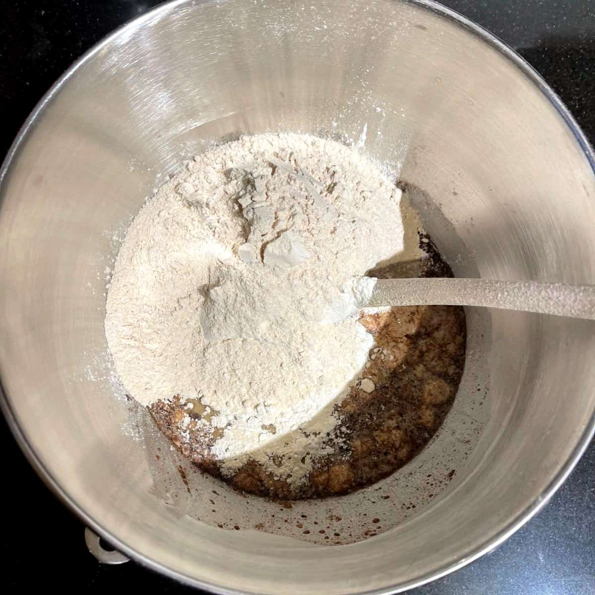 Flour added to cinnamon, maple, milk mixture in bowl