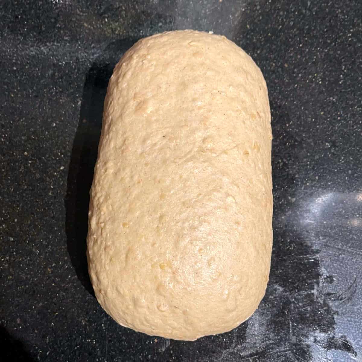 Dough folded into loaf for oatmeal bread.