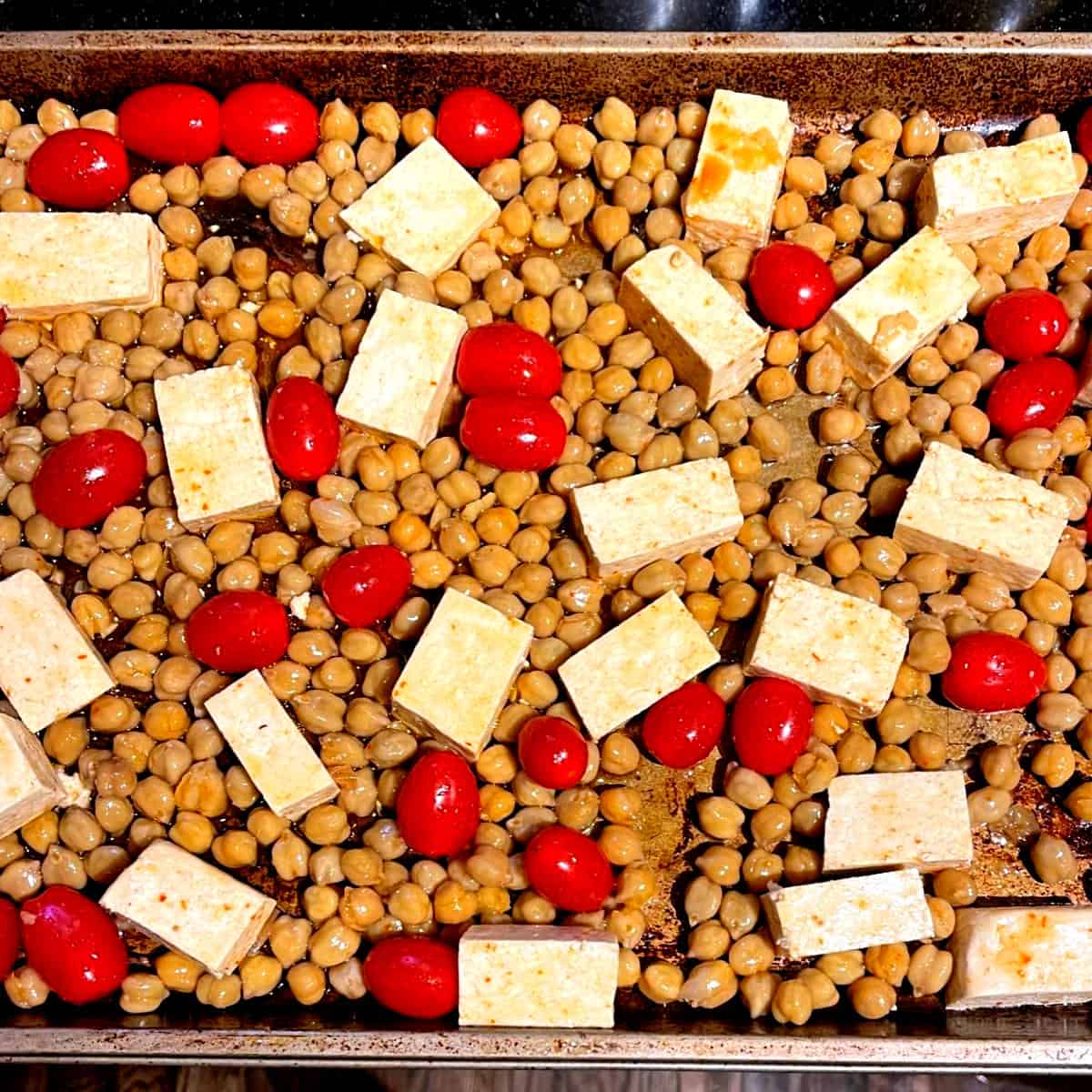 Tofu, chickpeas and tomatoes on sheet pan.