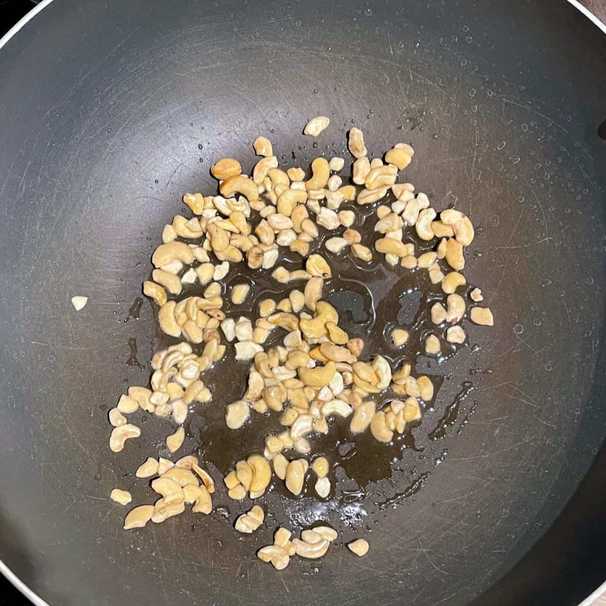 Cashews frying in wok.