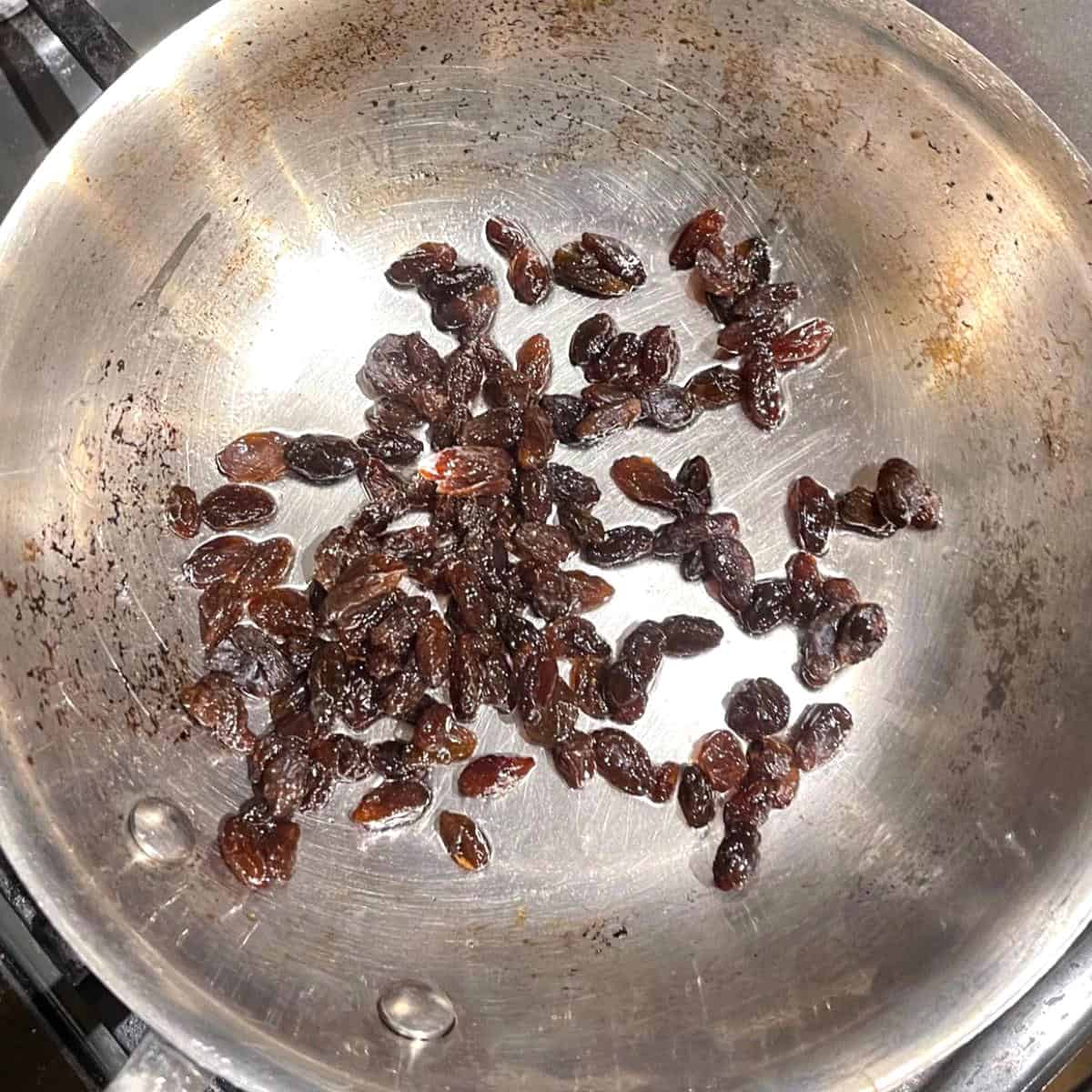 Raisins cooking in skillet.