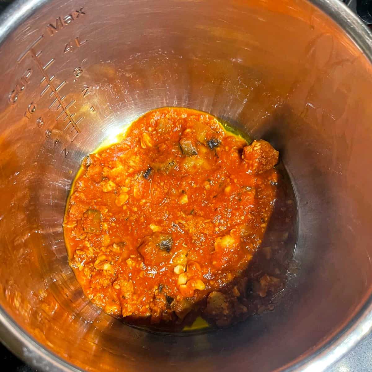 Layer of marinara sauce in the bottom of crockpot liner.