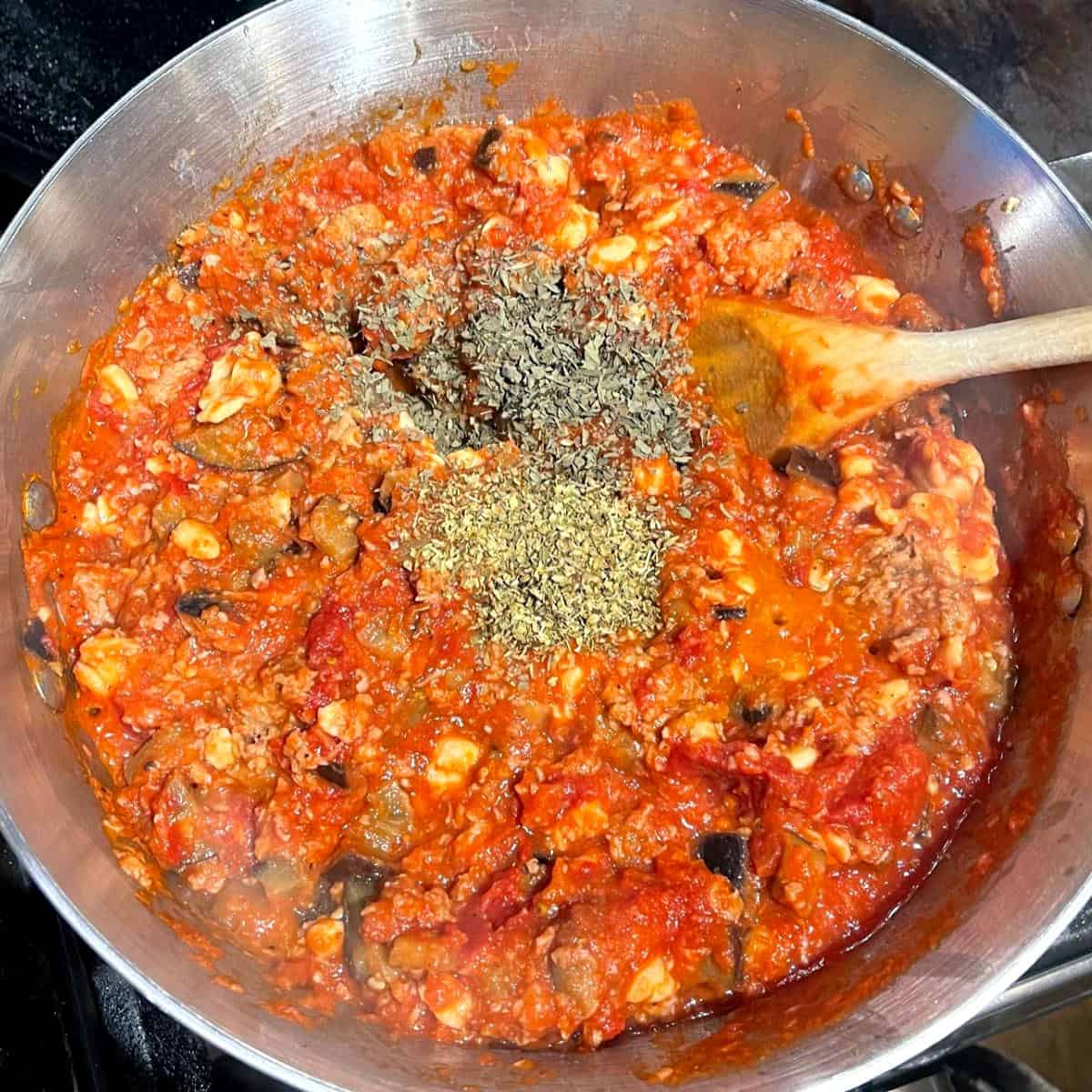 Basil and oregano added to marinara sauce.
