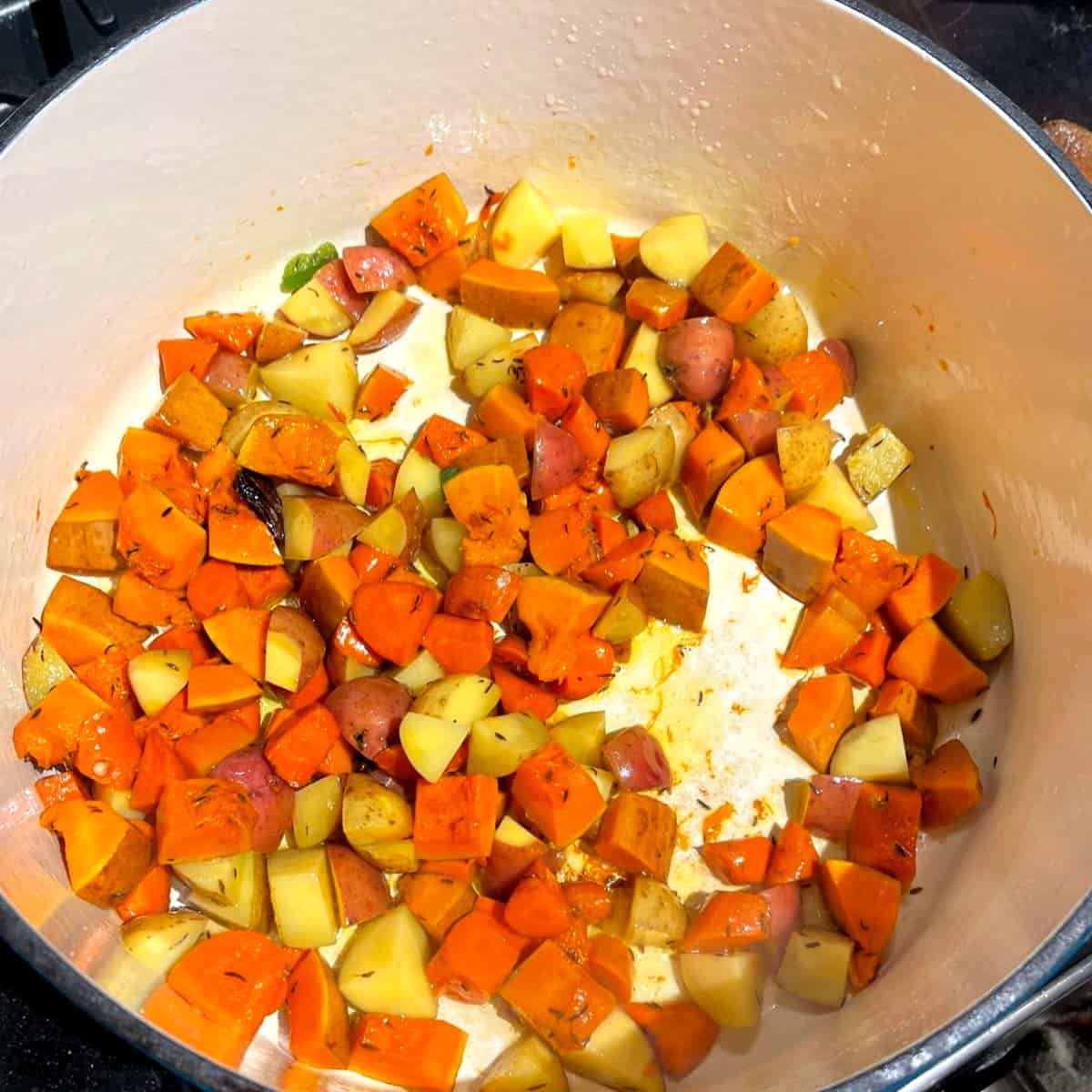 Potatoes and carrots in Dutch oven.