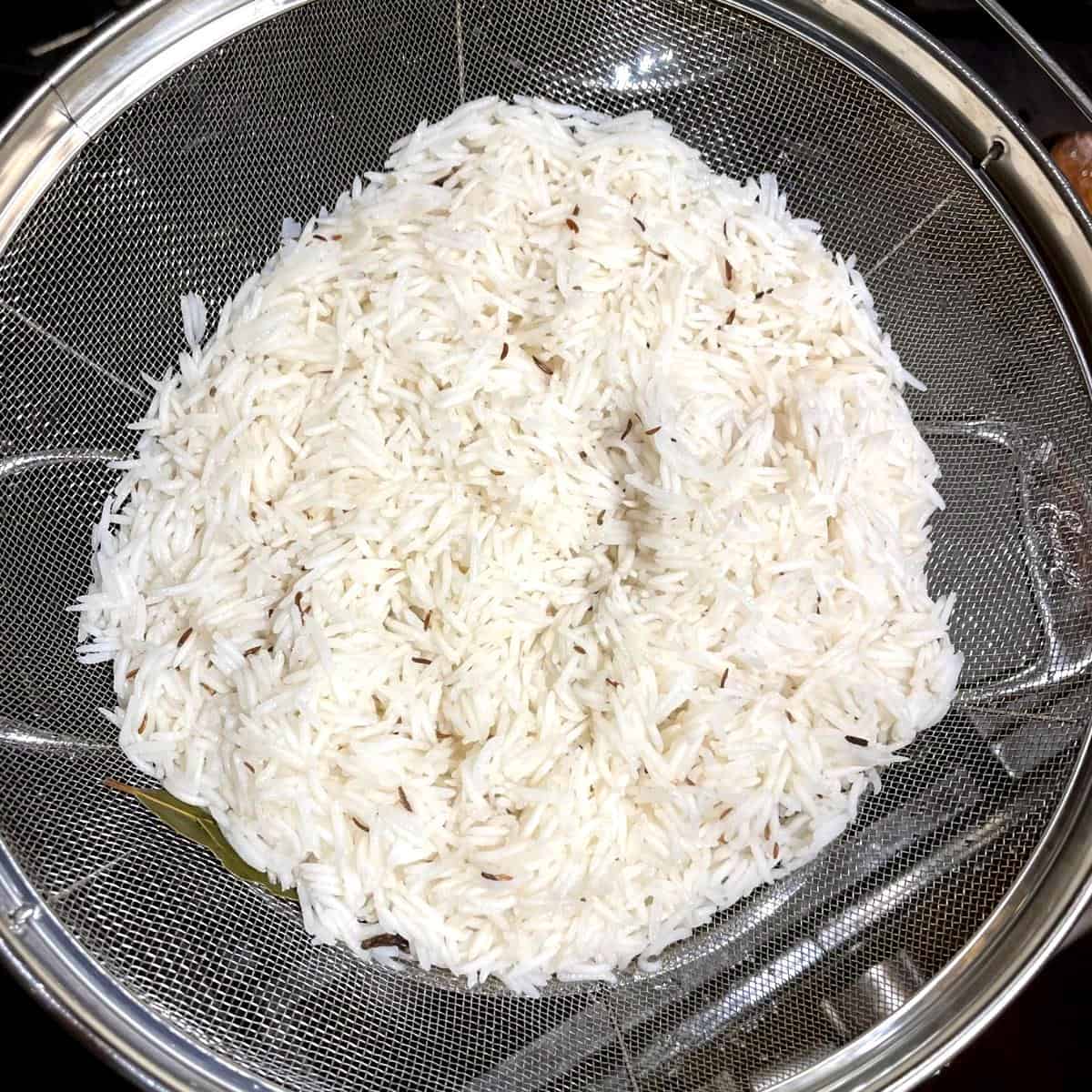 Cooked basmati rice washed and drained in colander.