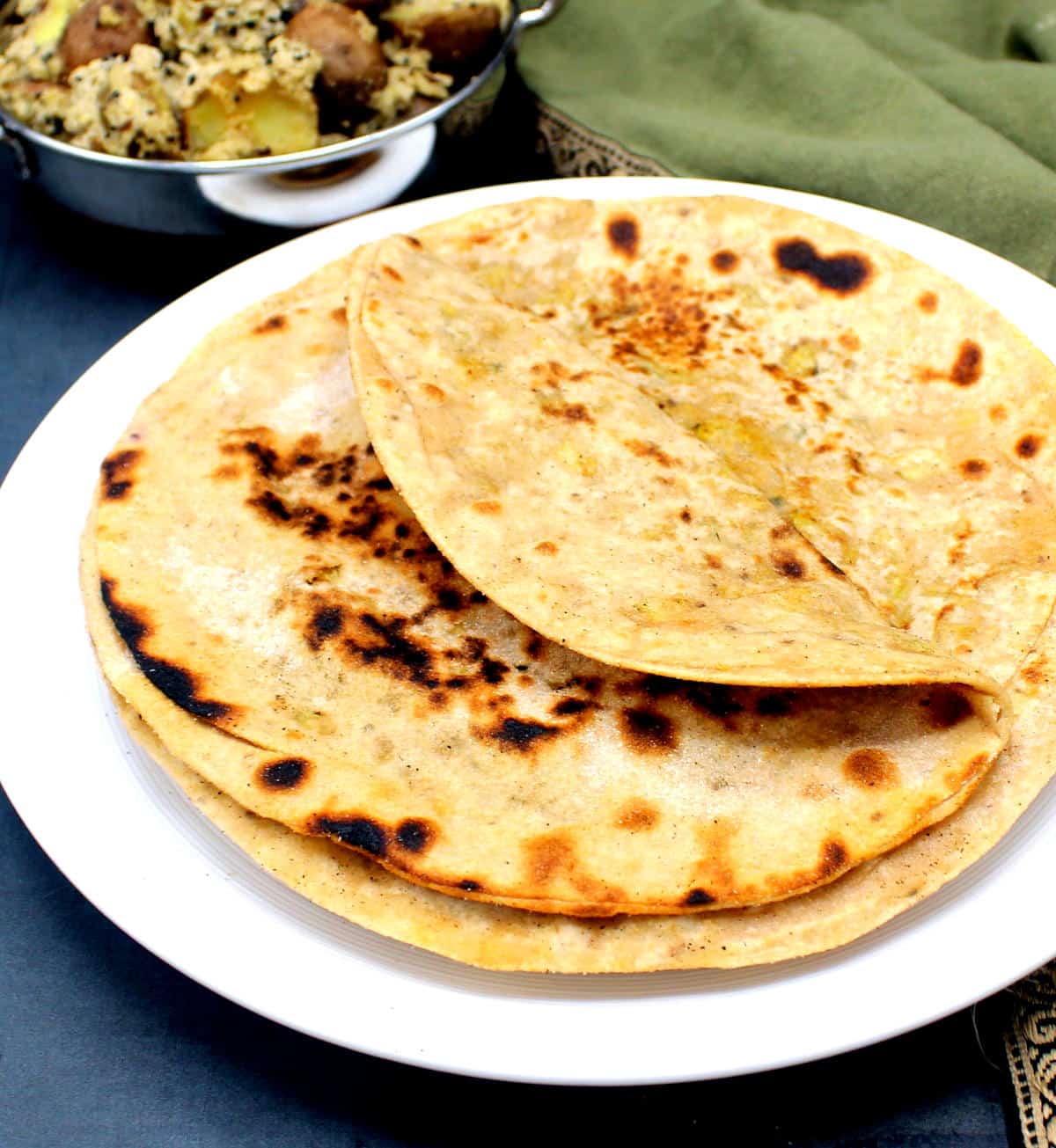 Gobi ka paratha stacked in a white plate.