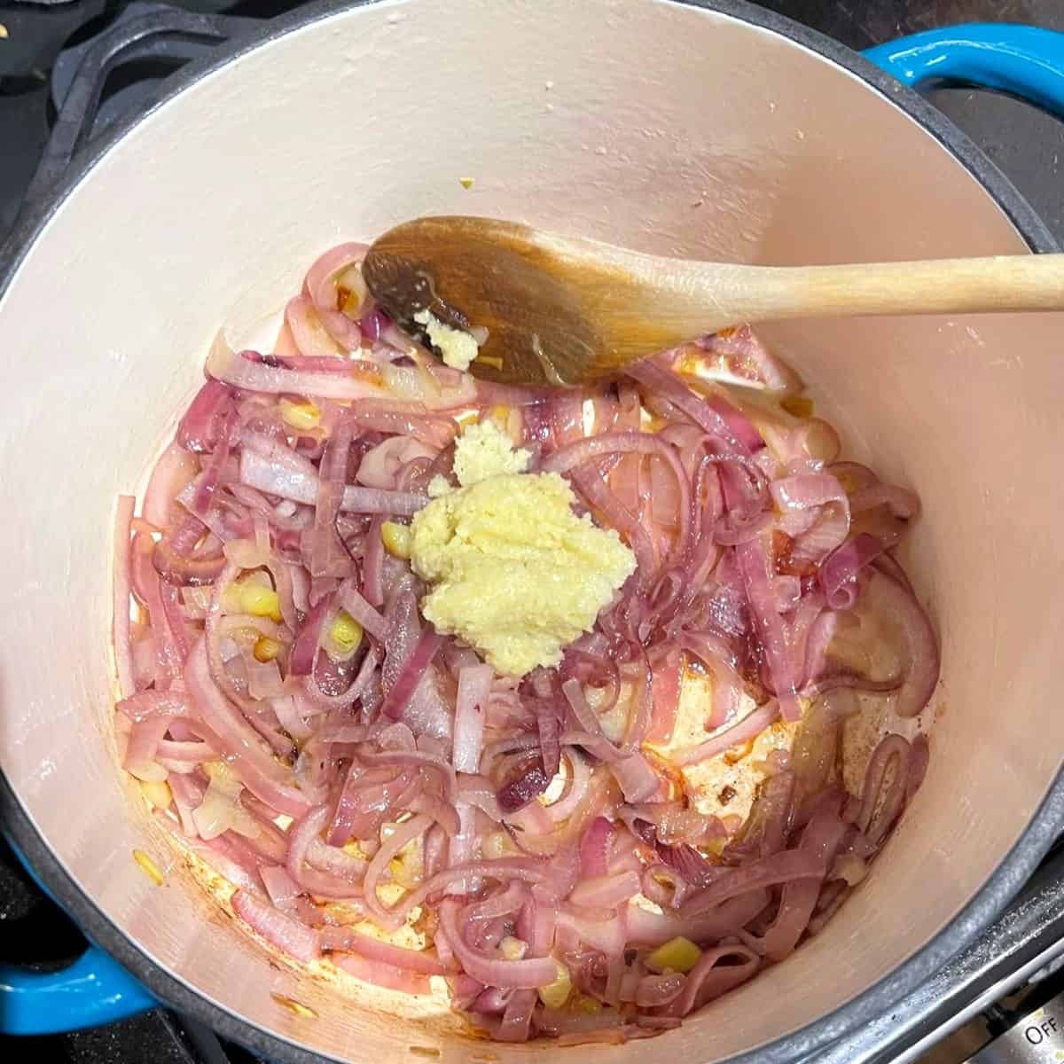 Garlic added to onions in Dutch oven.