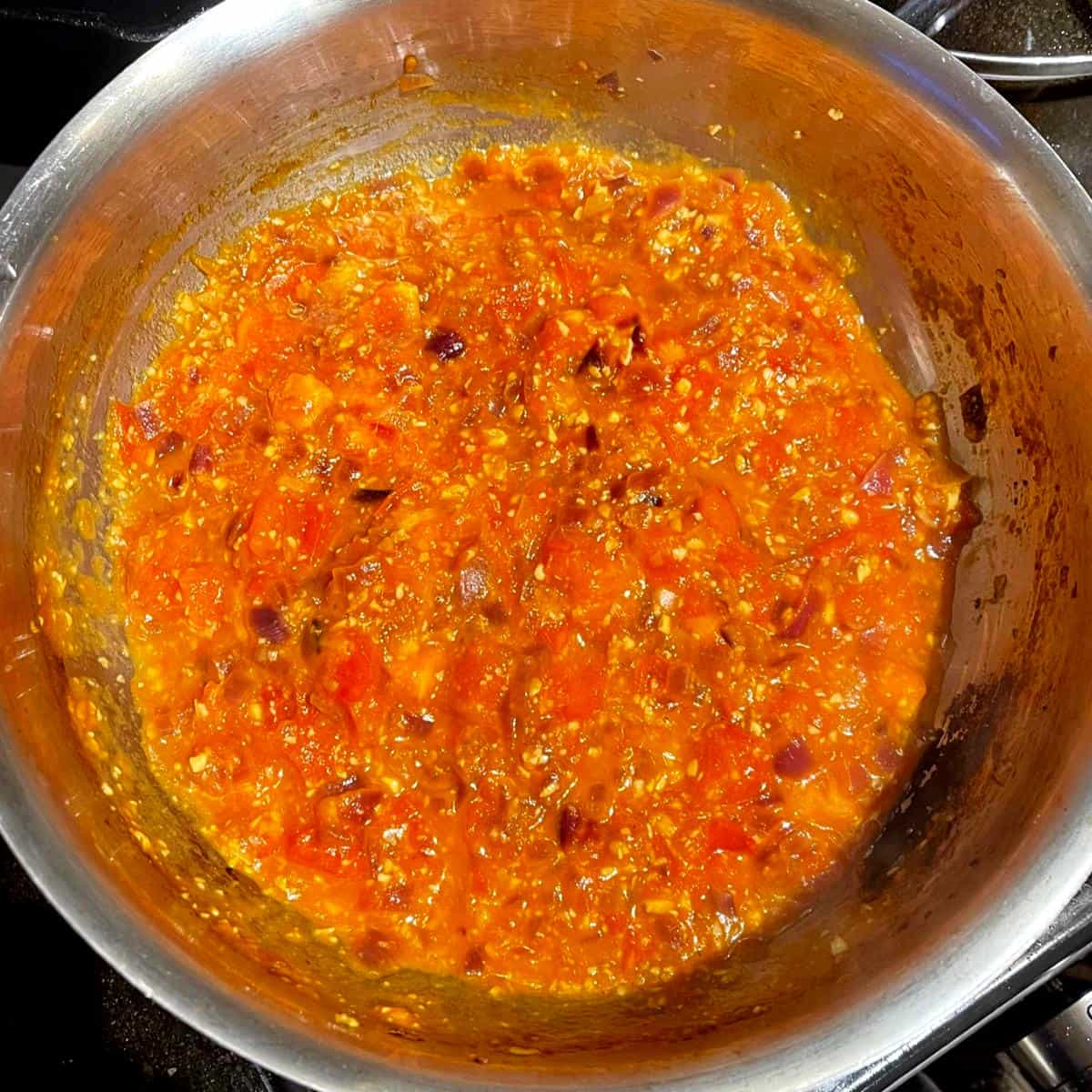 Tomatoes becoming pulpy in pan.