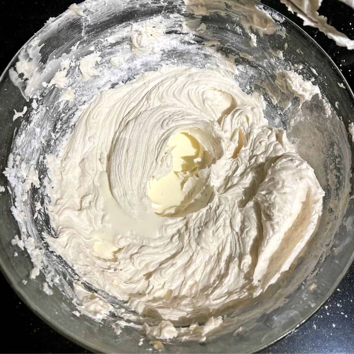 Vegan vanilla buttercream frosting topped with vegan cream.