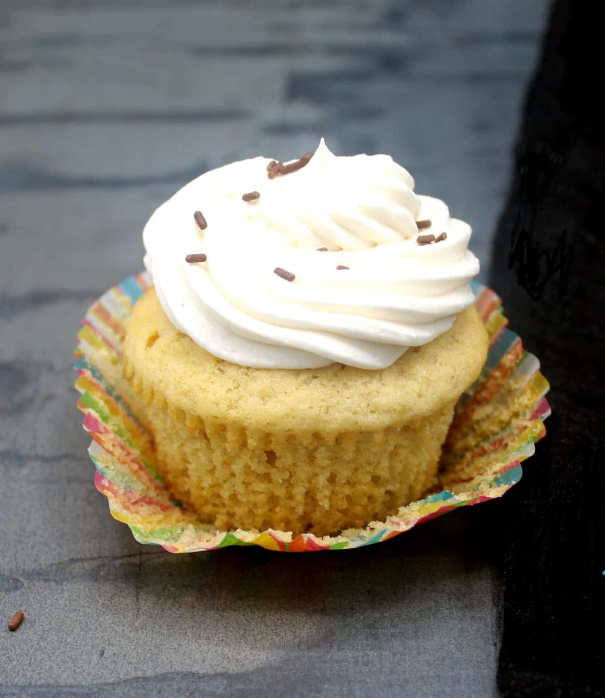 Vegan vanilla cupcake with liner opened.