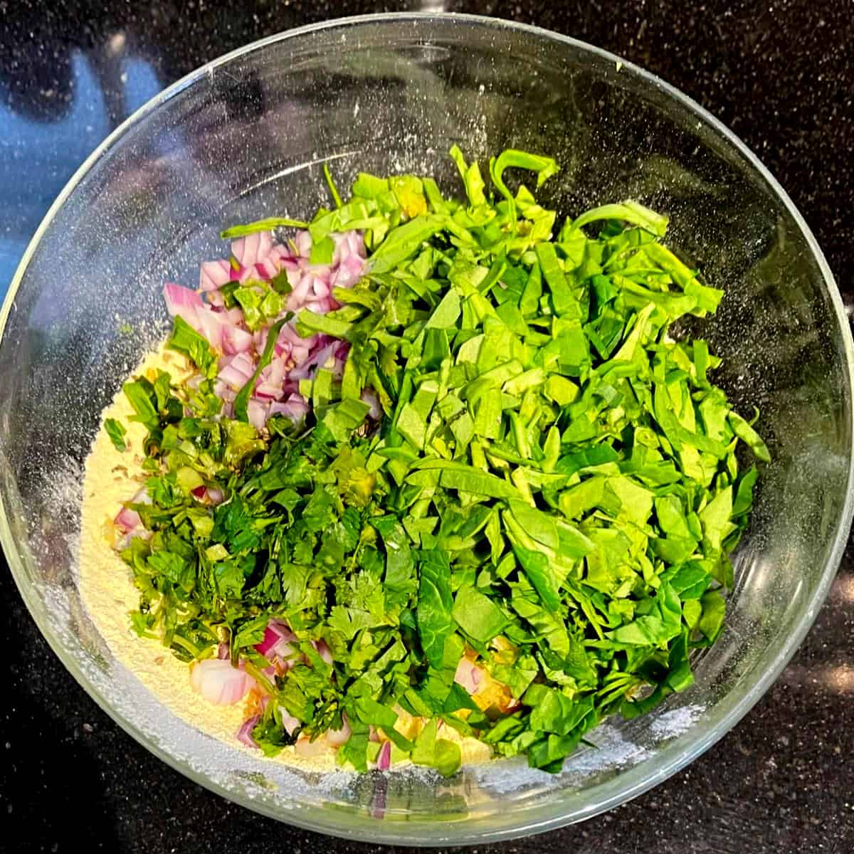 Spinach and cilantro added to besan chilla ingredients.