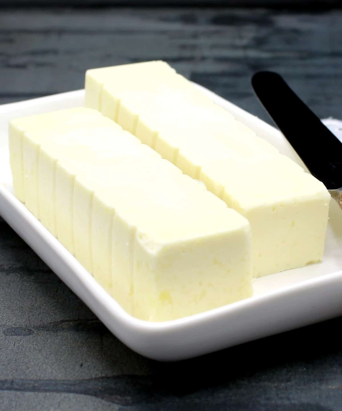 Vegan butter sticks in butter dish.