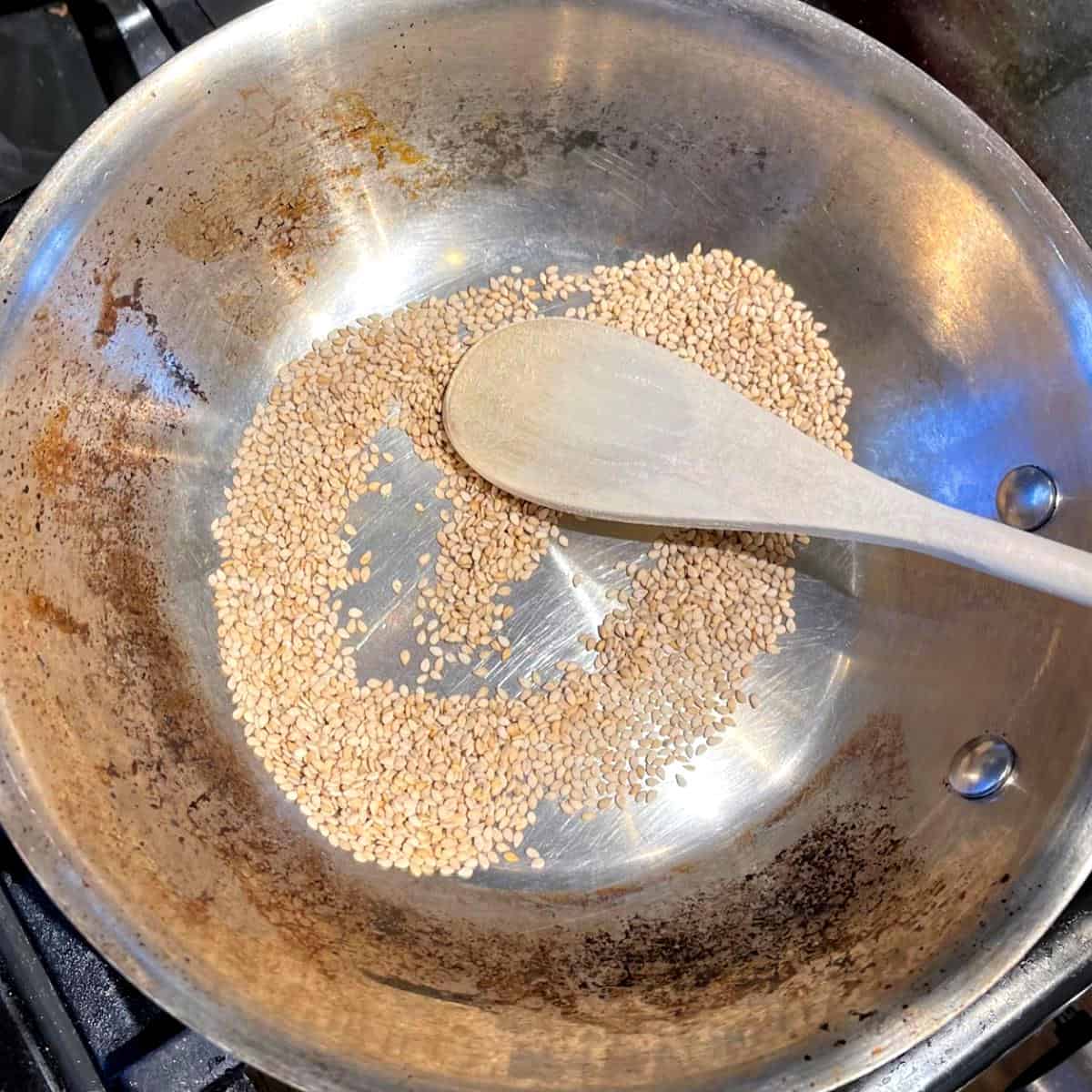 Sesame seeds toasting in skillet.