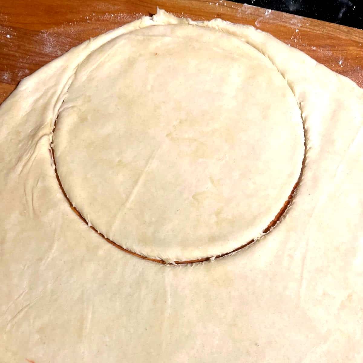 Six-inch disc cut out of empanada dough.