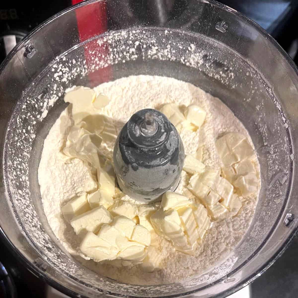 Vegan butter added to flour for vegan empanada dough.