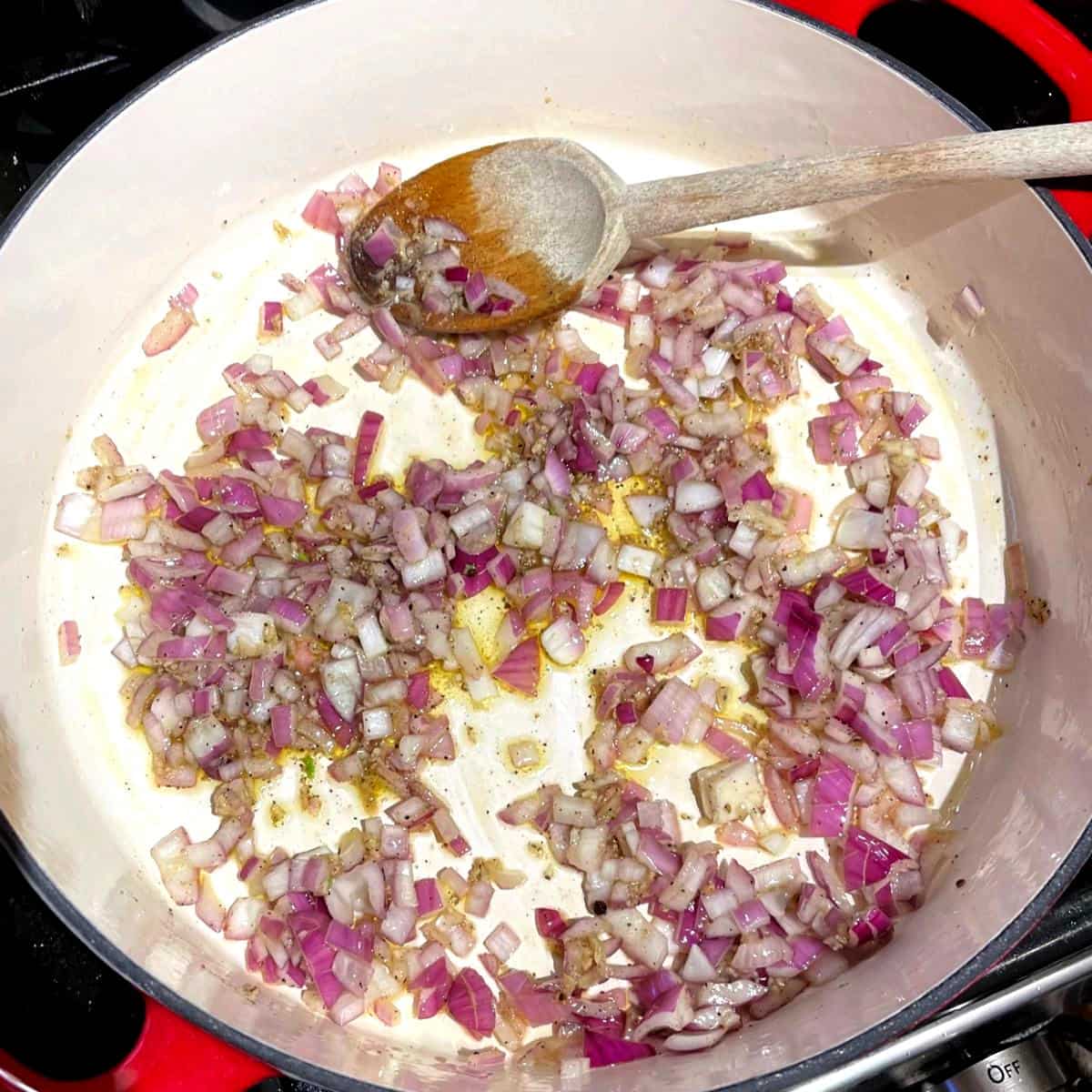 Oregano and pepper added to onions in skillet.