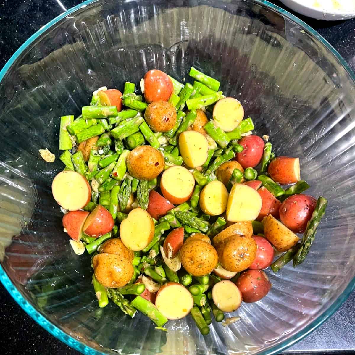 Toss potatoes and asparagus with olive oil and herbs in large bowl.