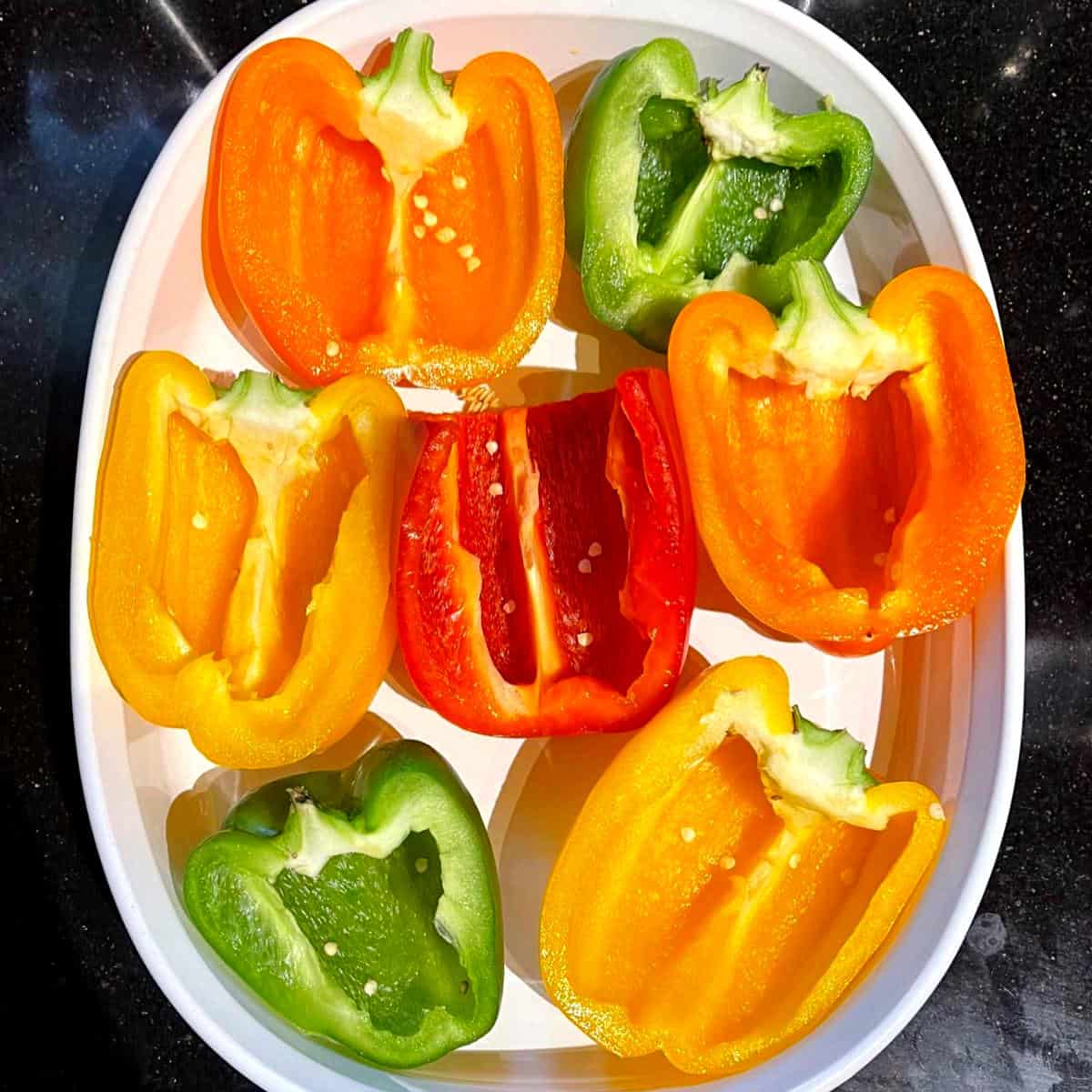 Cut bell peppers in baking dish.