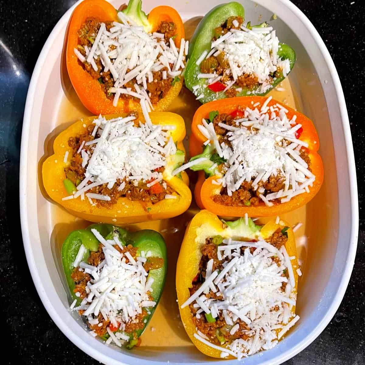 Bell peppers stuffed with vegan meat and vegan cheese filling.