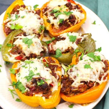 Vegan stuffed peppers on a white plate.