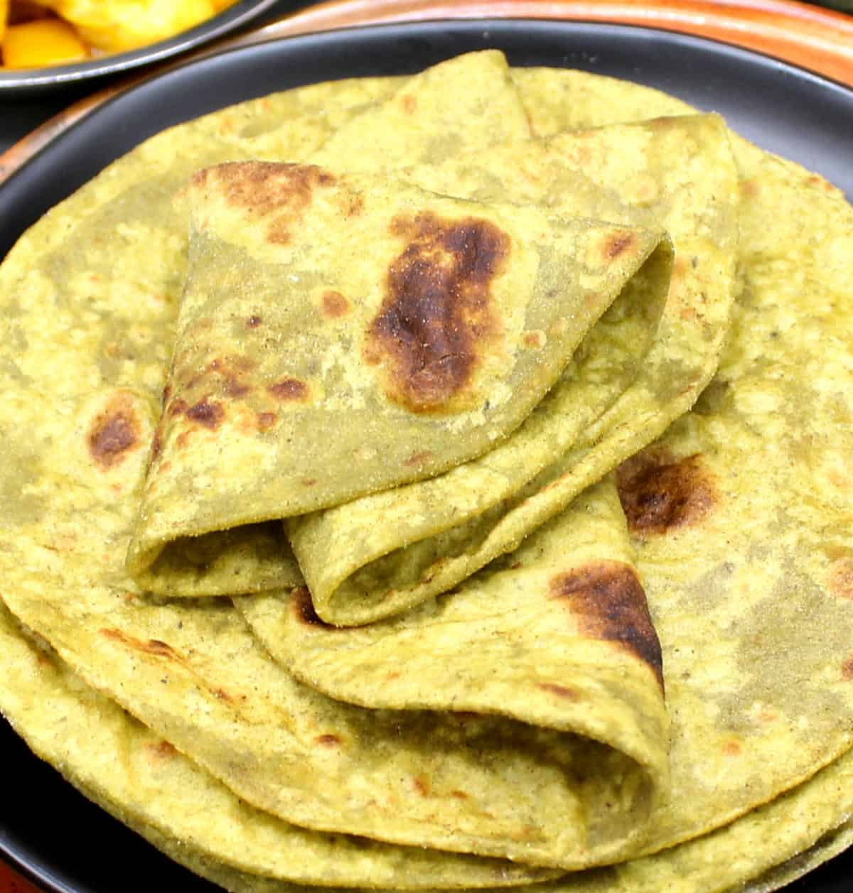 Soft high-protein roti on black plate.