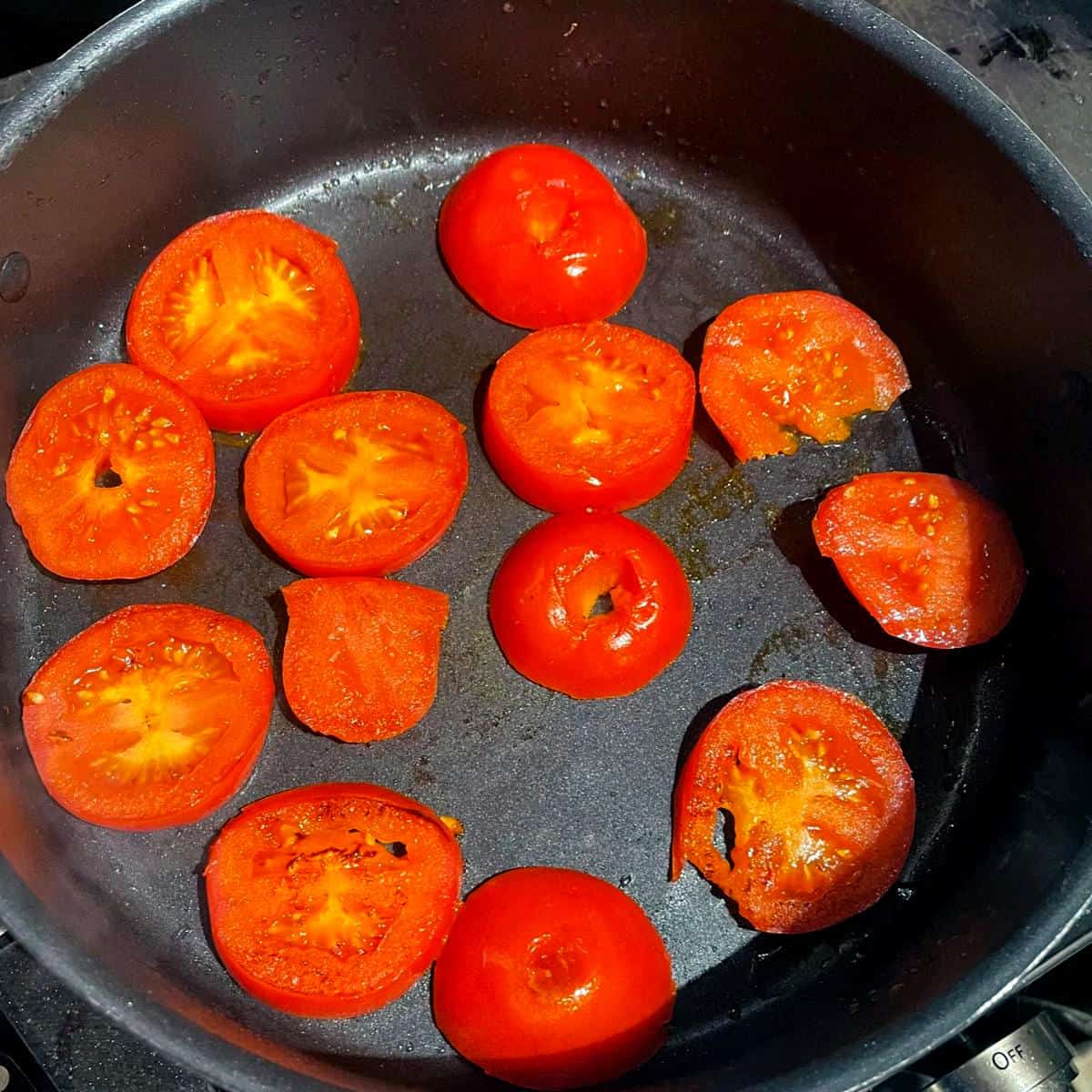 Tomatoes frying in saucepan for khoresht bademjan.