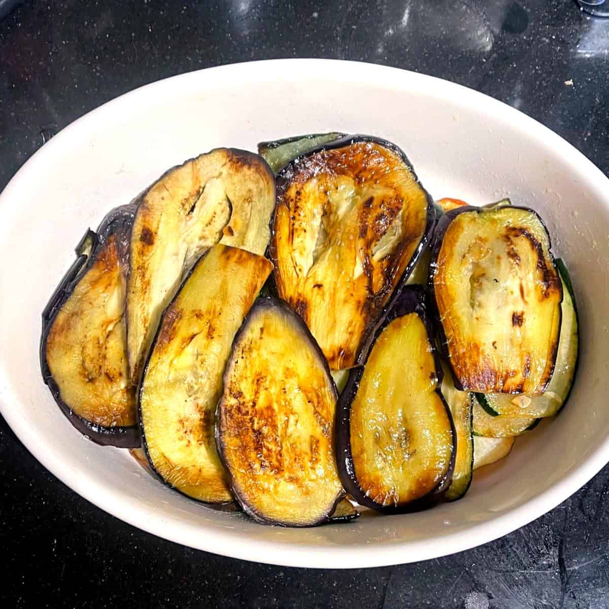Eggplants layered over zucchini for vegan moussaka.