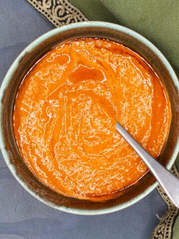 Calabrian chili paste in bowl with spoon.
