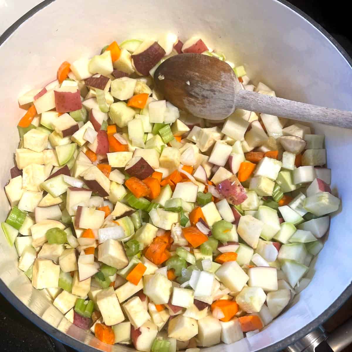 Veggies cooking in dutch oven for mixed veg stew.