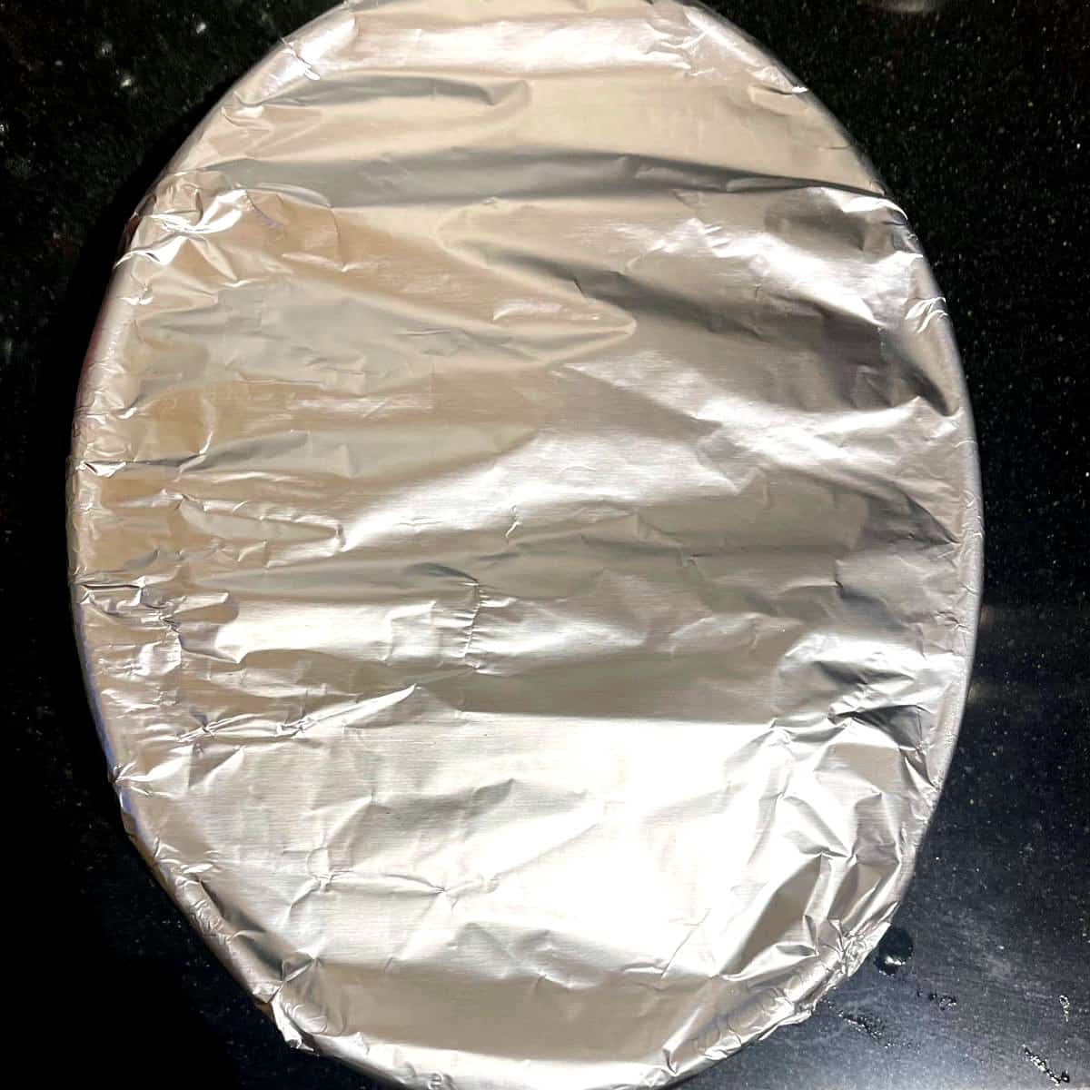 Baking dish covered with aluminum foil before baking.