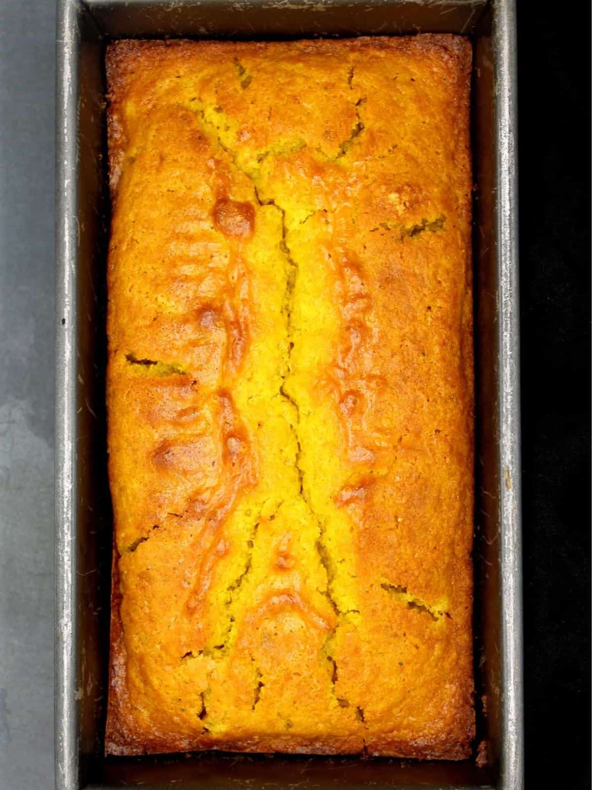 Vegan cardamom turmeric cake in loaf pan.