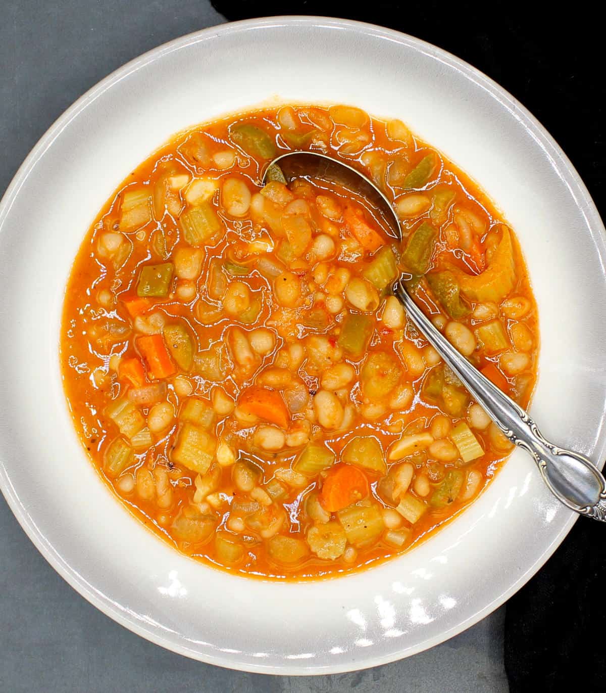 Greek white bean soup fasolada in a bowl with spoon.