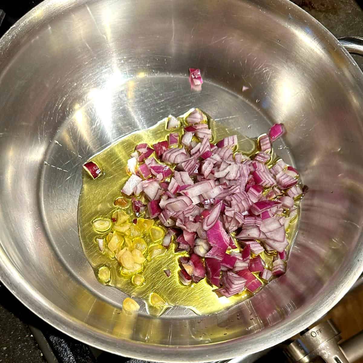 Onions and garlic sauteing in olive oil.