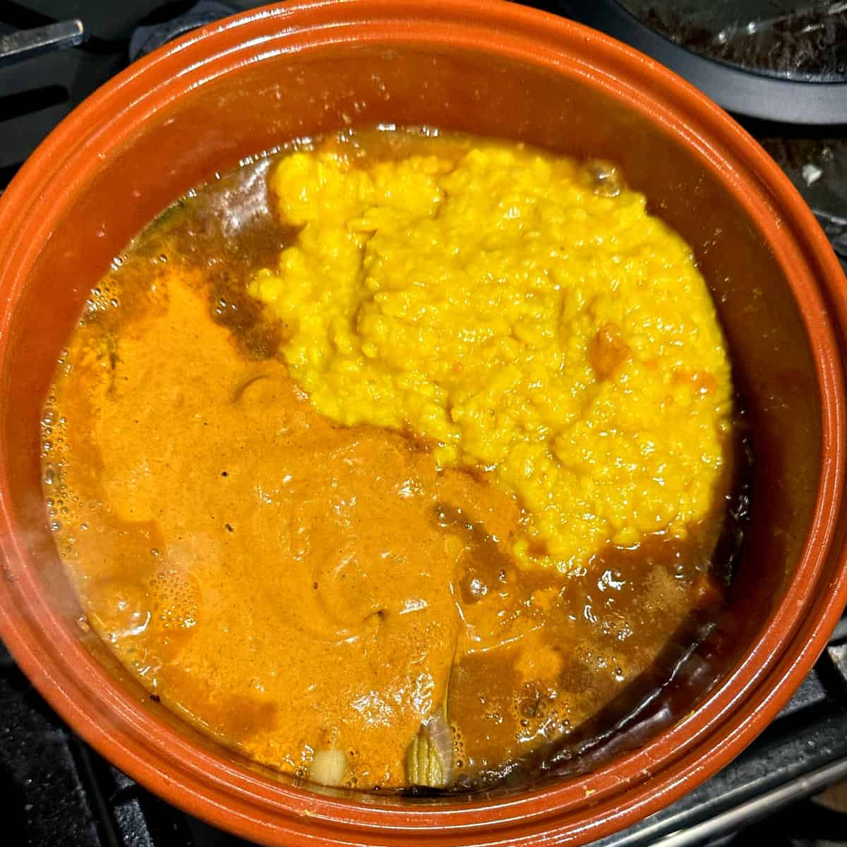 Dal and fresh-ground masala added to pot.