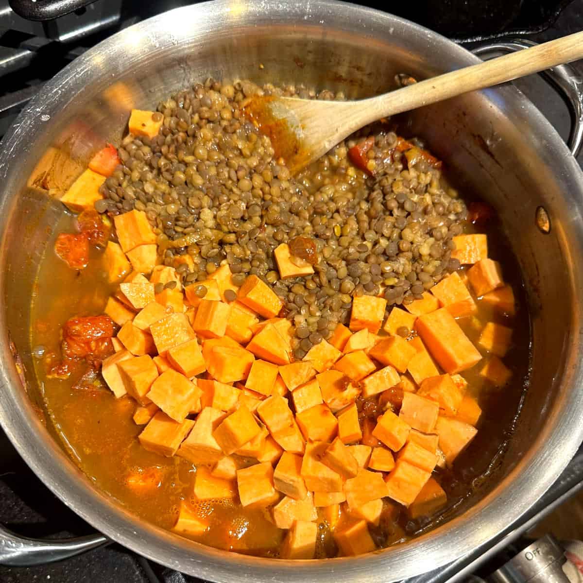 Lentils and sweet potatoes added to pot.