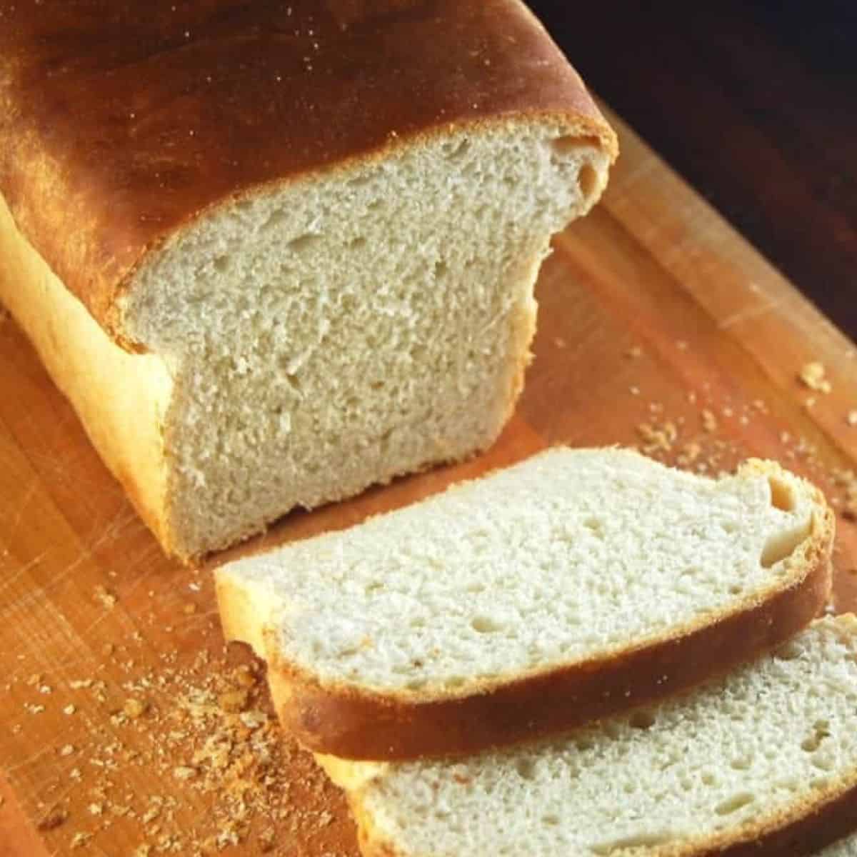 Sliced sourdough sandwich bread on cutting board.