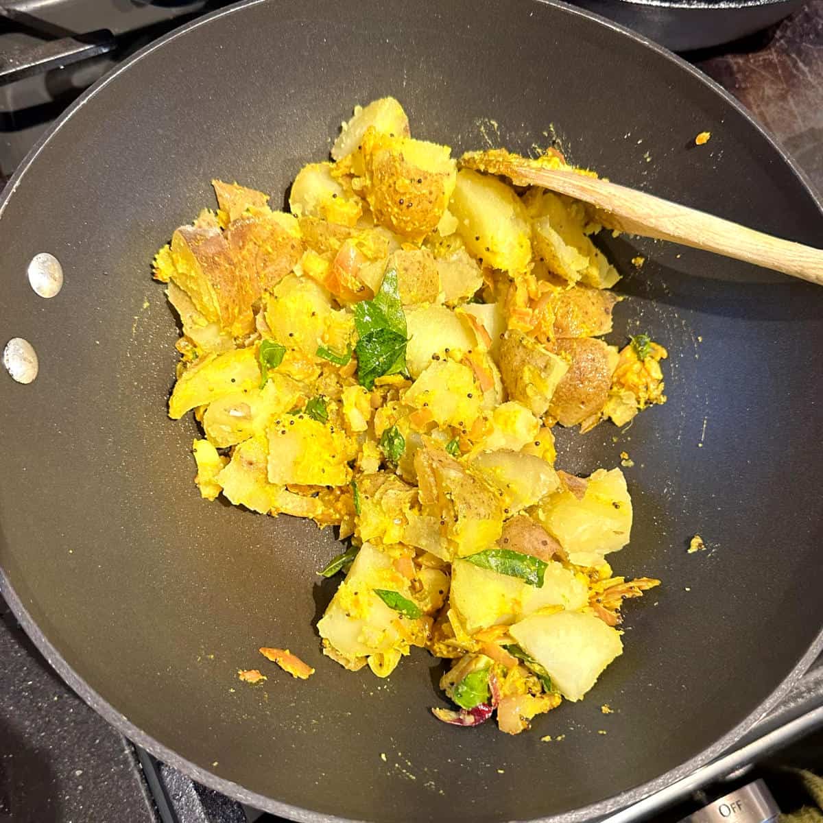 Potatoes cooking in wok.