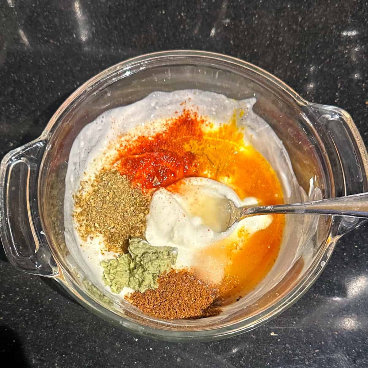 Spices added to vegan yogurt for tikka masala marinade.