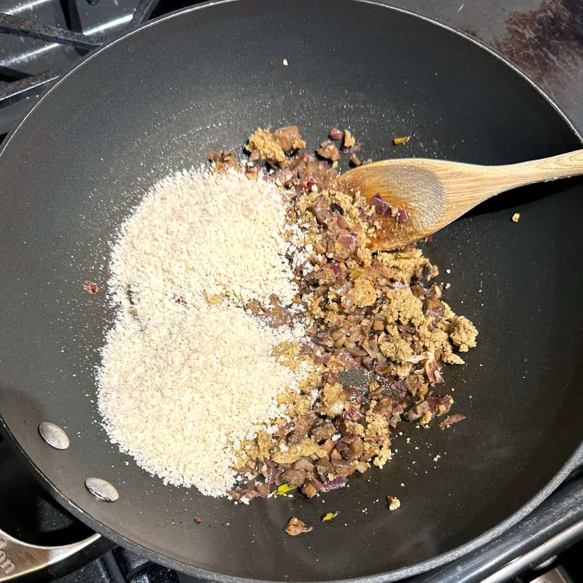 Walnut mixture and panko breadcrumbs added to wok.