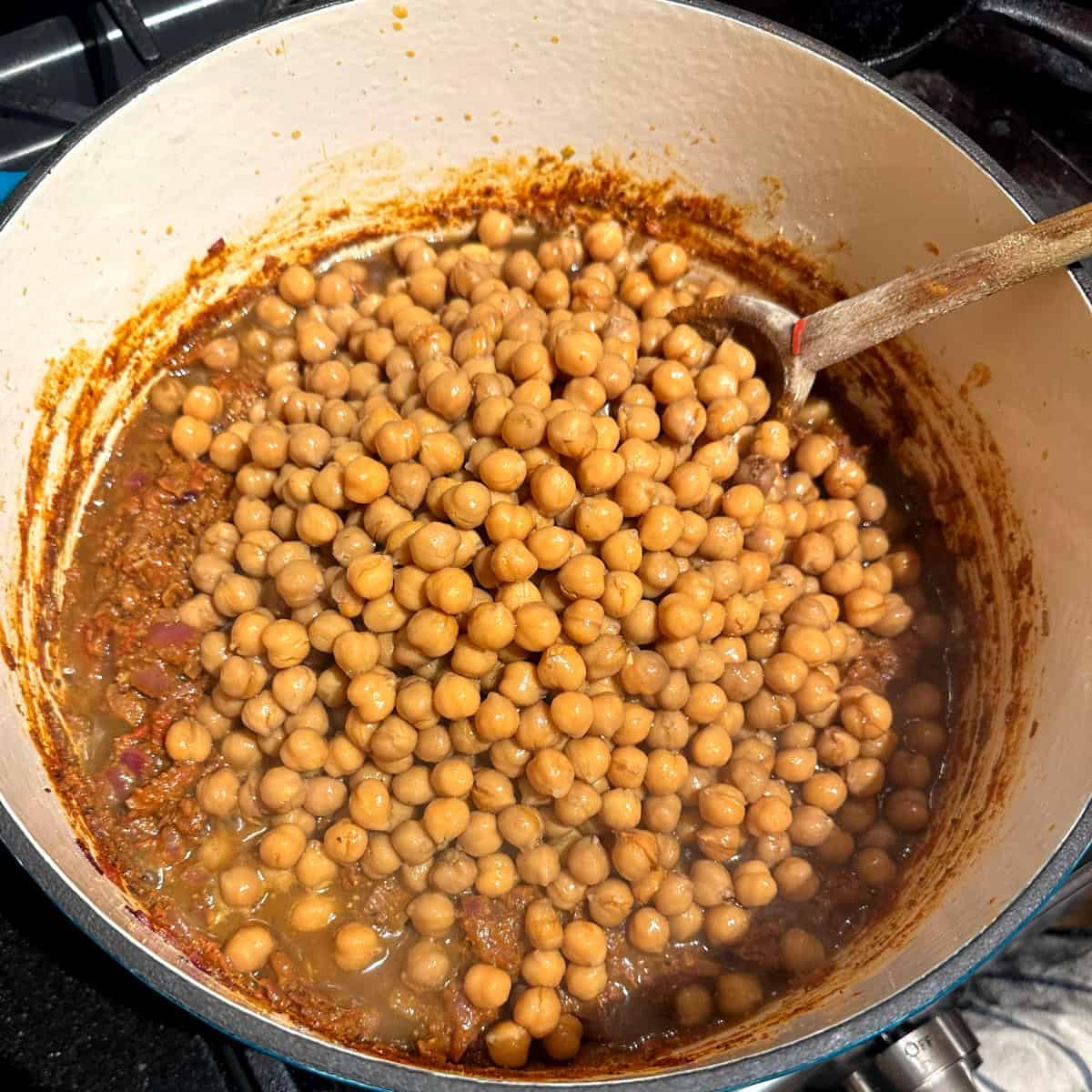 Chickpeas added to tomatoes and onions.