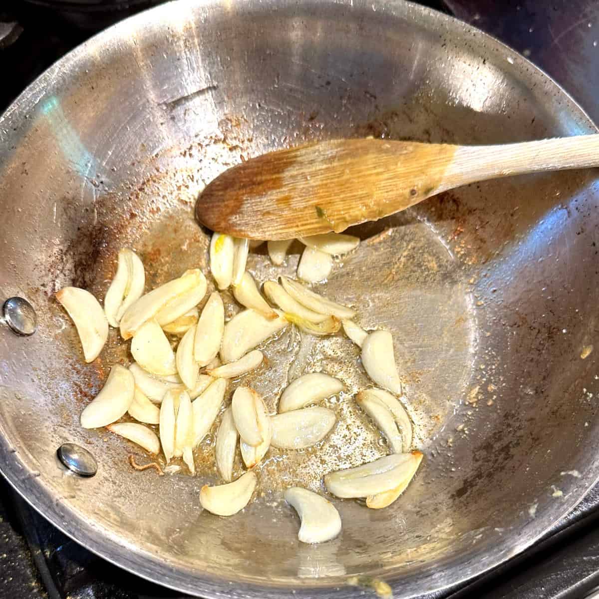 Sliced garlic cloves in small saucepan.