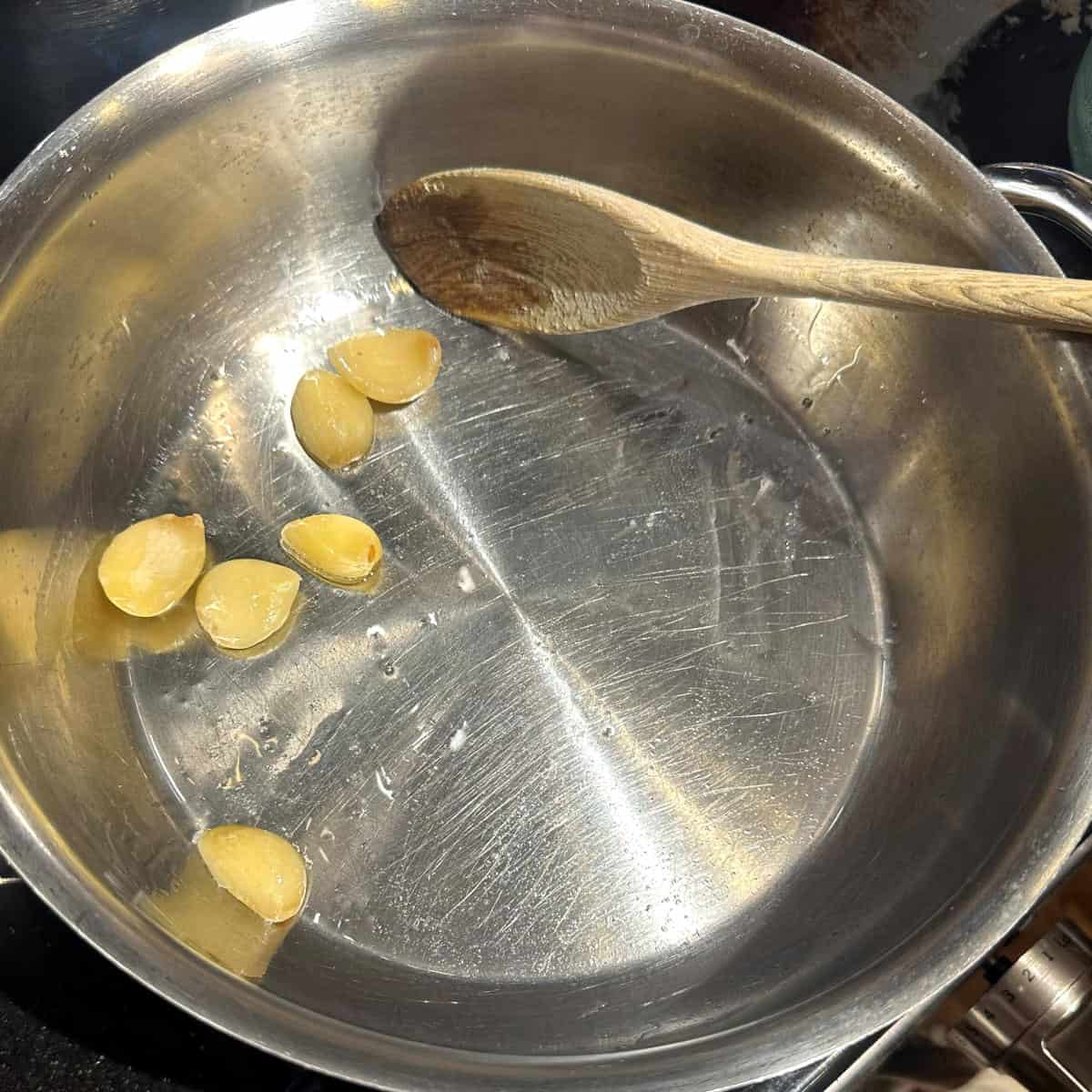 Garlic in oil in pan.