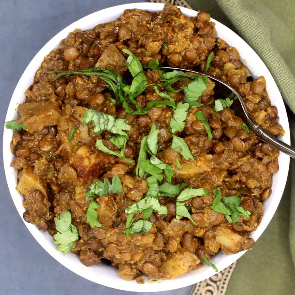 Slow cooker lentils or masoor keema in bowl with spoon.
