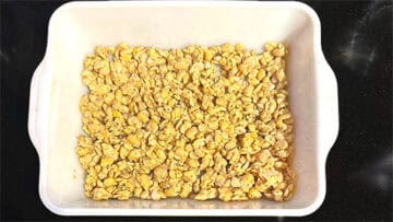Crumbled and seasoned tempeh in baking dish.